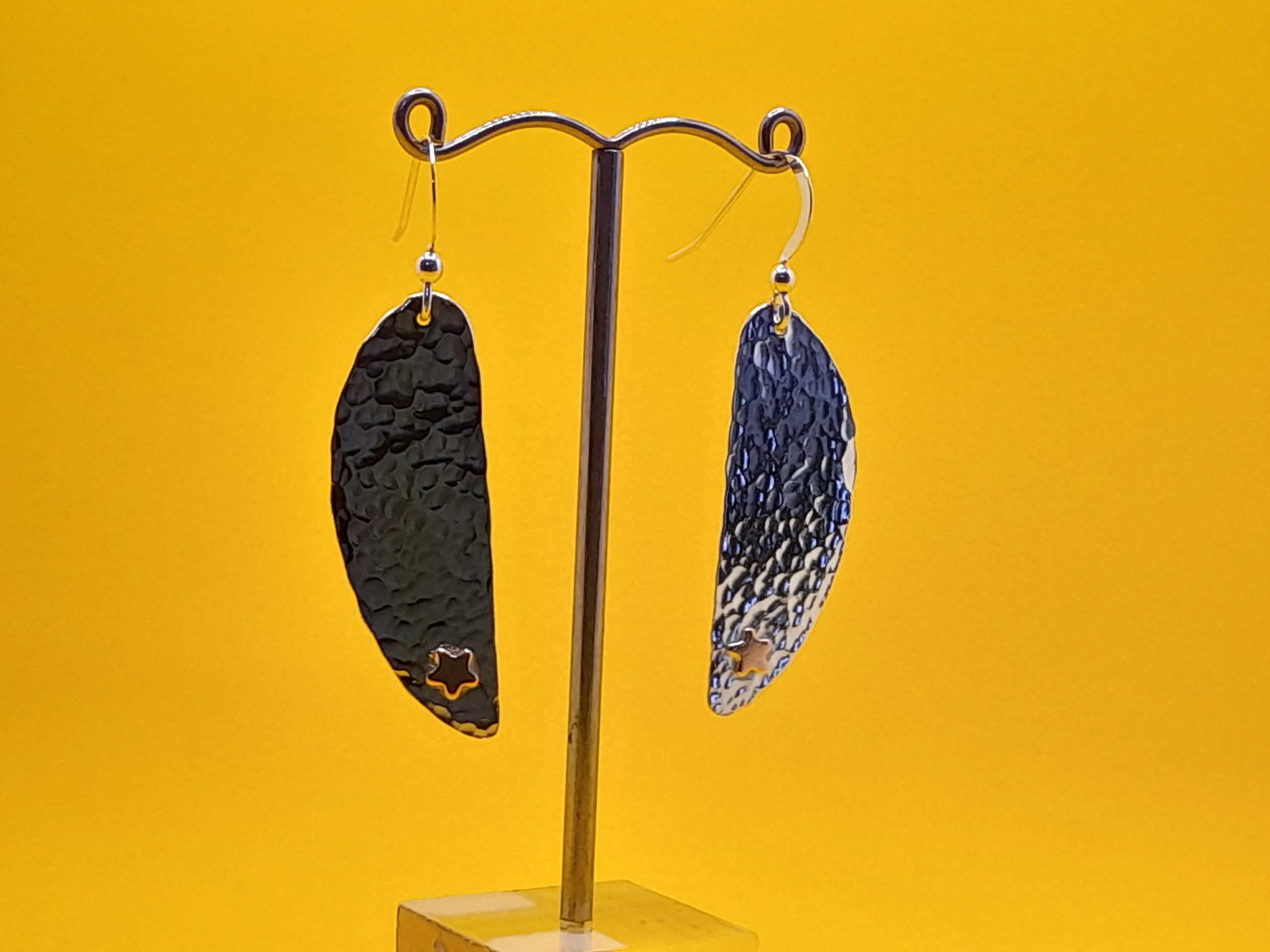Silver Earrings made from a flatten coffee spoon bowl with added copper stars - Image 2